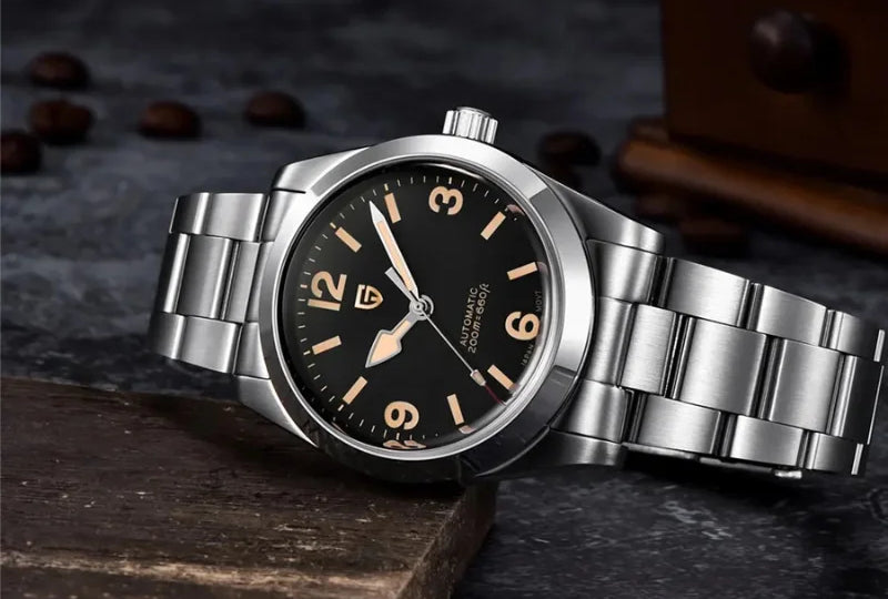 Asterion automatic watch with AUTOMATIC 200M printed on its black dial, resting on stone