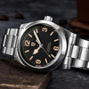 Asterion automatic watch with AUTOMATIC 200M printed on its black dial, resting on stone