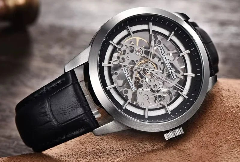 Pagani Design Artisan open dial watch, steel case with skeleton dial and black leather strap on a wooden surface