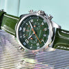 Green Aero Chronograph by Pagani Design against an iridescent striped backdrop, strap curving forward