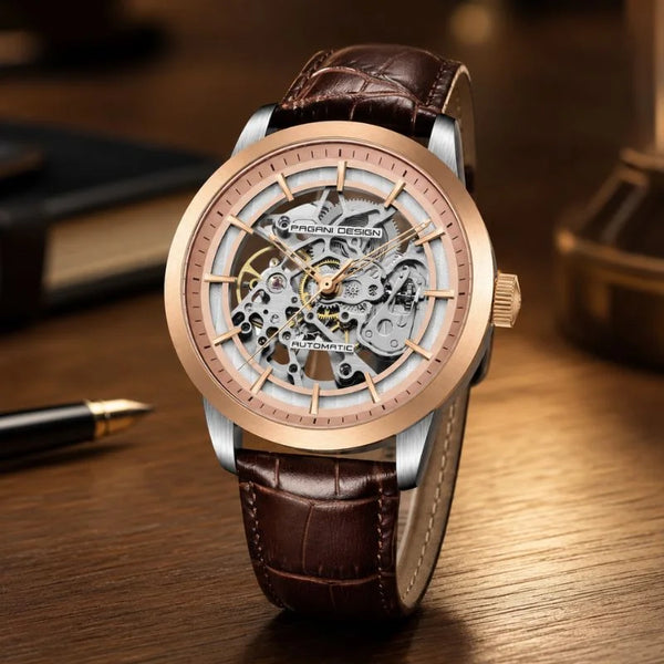 Artisan Open Dial de oro rosa de Pagani Design sobre un escritorio junto a una pluma estilográfica