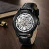All-black Artisan Open Dial by Pagani Design on a dark desk with brass accessories
