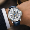 Man in a navy suit wearing the blue-strap Artisan Open Dial by Pagani Design