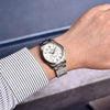 Man in a striped shirt wearing the white-dial Aurum Frost by Pagani Design