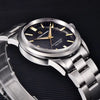 Close-up of the black-dial Aurum Frost by Pagani Design angled on a ribbed surface