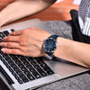 Man wearing the Blue Meridian watch by Pagani Design while typing on a laptop
