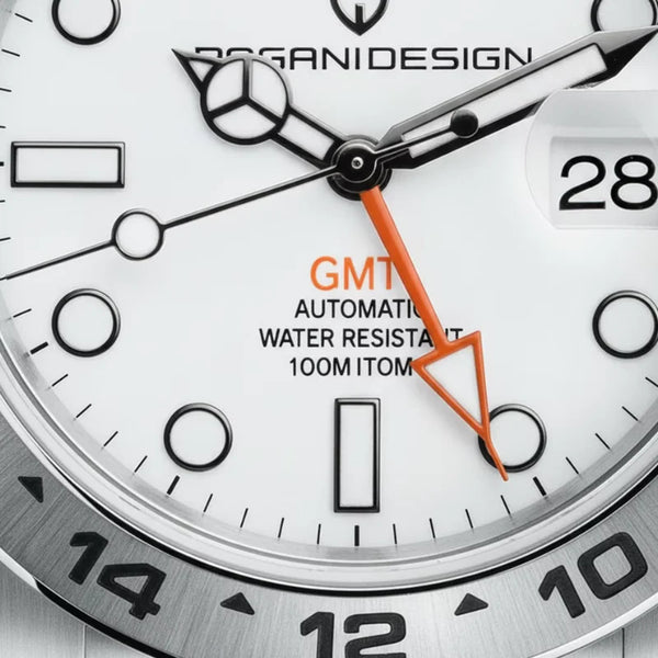 Macro of the Explorer dial by Pagani Design showing the orange GMT hand and 100 m rating