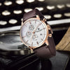 Rose gold Royal Chrono by Pagani Design resting beside a vintage typewriter