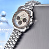 Saturn chronograph by Pagani Design leaning on a brushed metal edge against a blue backdrop