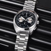 Black-dial Sterling Chrono by Pagani Design against a black ribbed backdrop